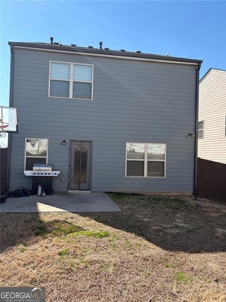 back of property featuring a patio area and fence