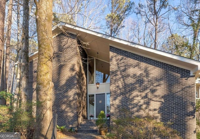 view of home's exterior with brick siding