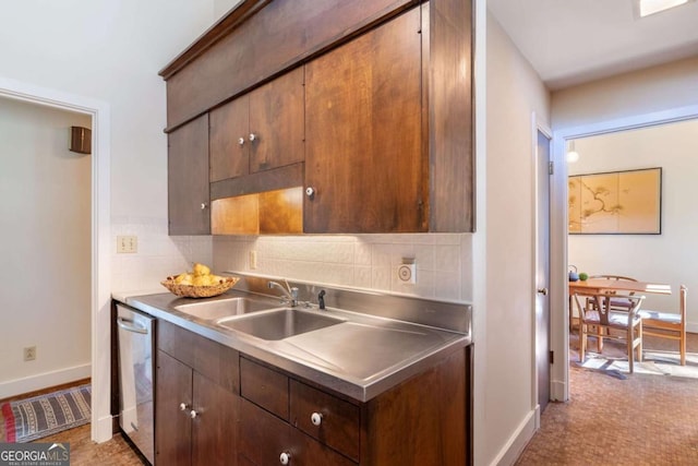 kitchen featuring baseboards, decorative backsplash, a sink, stainless steel counters, and stainless steel dishwasher