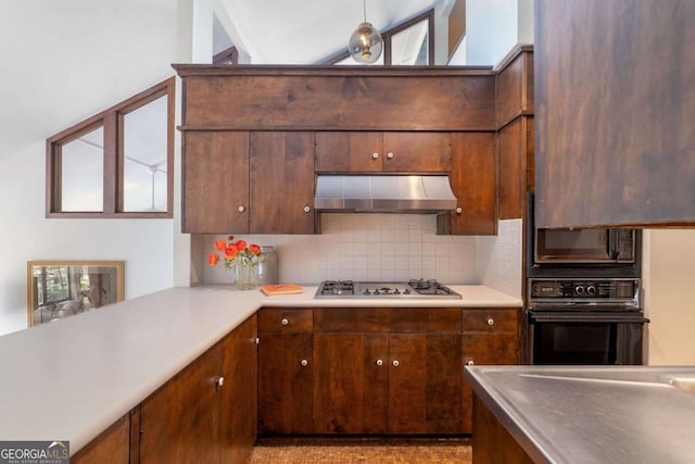 kitchen with backsplash, light countertops, under cabinet range hood, and black appliances