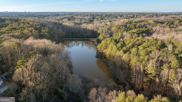 aerial view with a water view and a wooded view