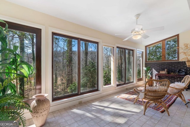 sunroom with a ceiling fan and a wealth of natural light