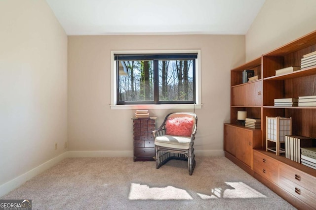 living area with light colored carpet and baseboards