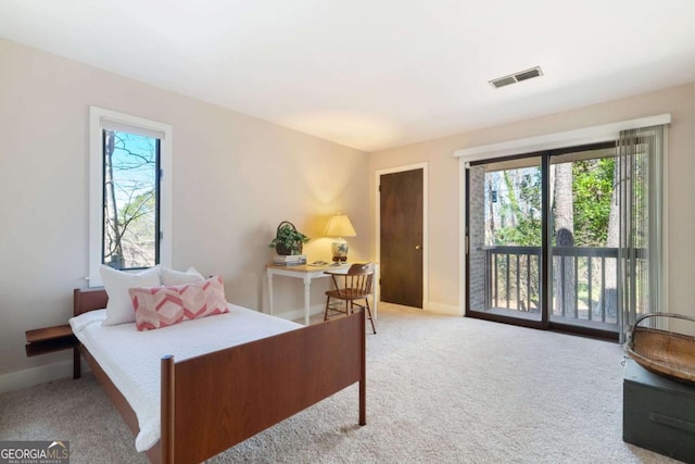 bedroom with access to exterior, light colored carpet, visible vents, and baseboards