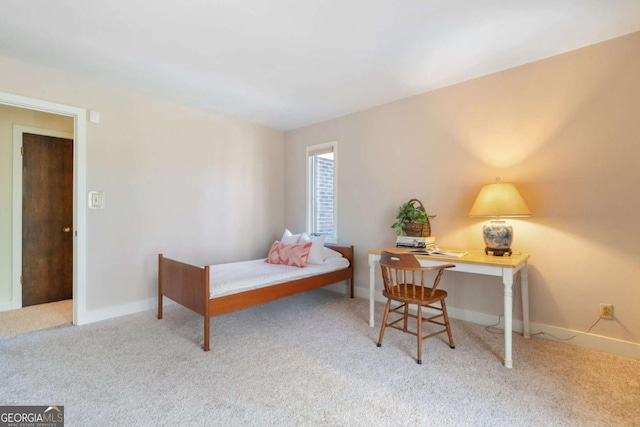 bedroom with light colored carpet and baseboards