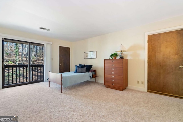 bedroom with light carpet, visible vents, and access to exterior