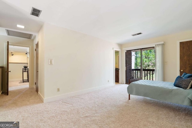 bedroom featuring visible vents, light colored carpet, attic access, and access to exterior