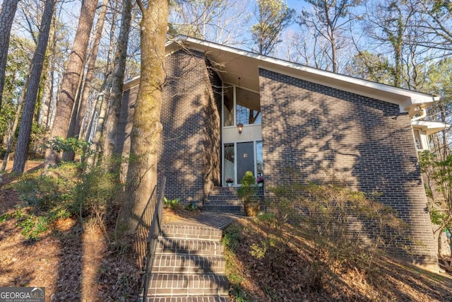 view of front of house featuring brick siding