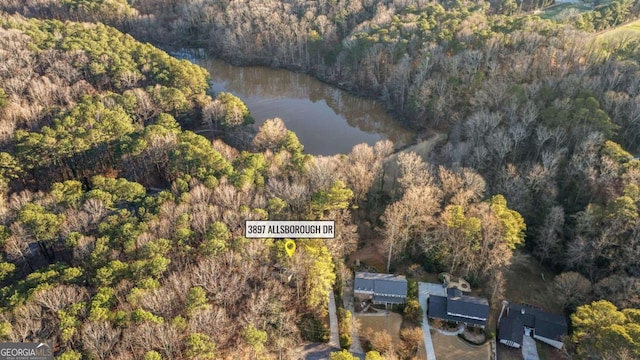 birds eye view of property featuring a water view and a forest view