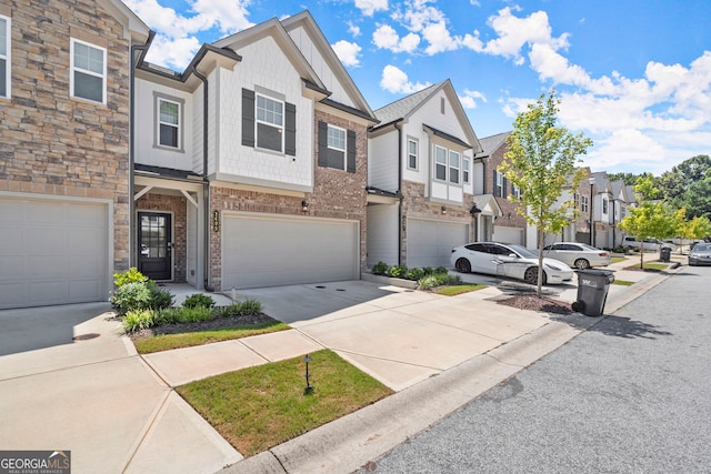 view of property featuring a residential view, brick siding, driveway, and an attached garage