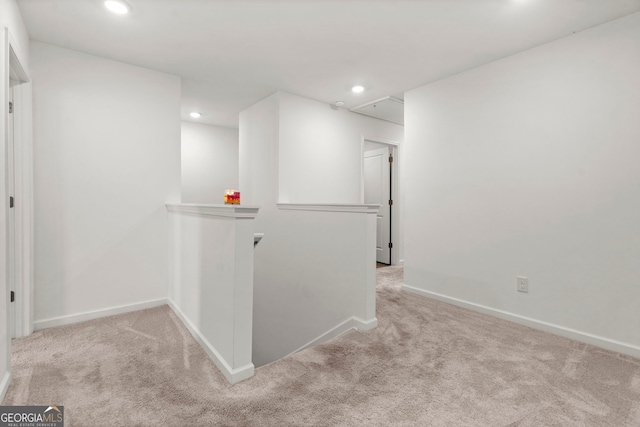 hallway featuring attic access, recessed lighting, light colored carpet, and an upstairs landing