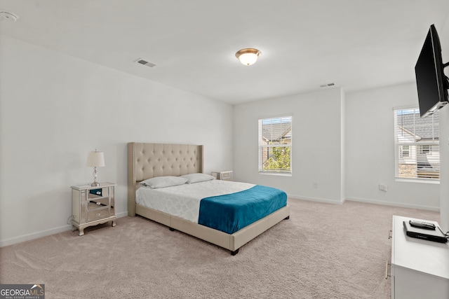 carpeted bedroom featuring visible vents and baseboards