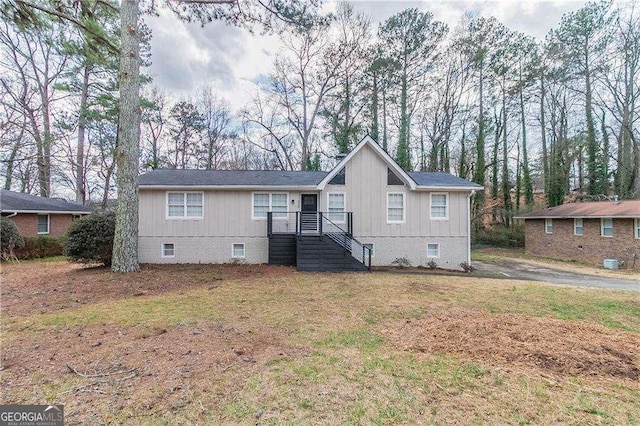 view of front of house with a front yard and crawl space