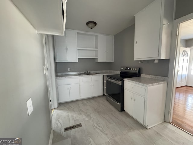 kitchen featuring white cabinetry, light countertops, stainless steel electric range, and open shelves