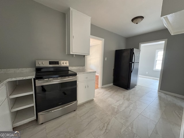 kitchen featuring open shelves, stainless steel electric stove, light countertops, freestanding refrigerator, and white cabinetry