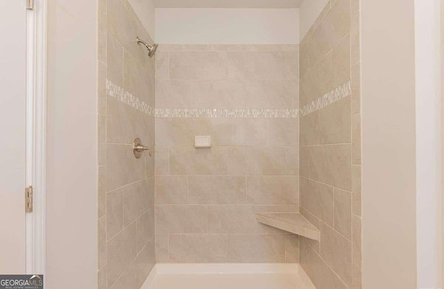 bathroom with tiled shower