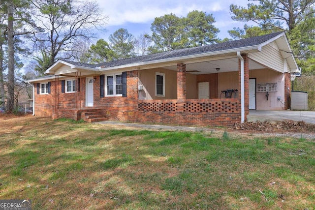 single story home with a front yard and brick siding