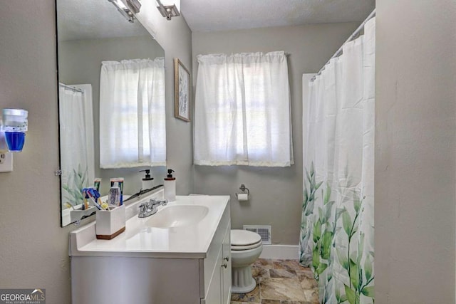 bathroom with toilet, baseboards, visible vents, and vanity