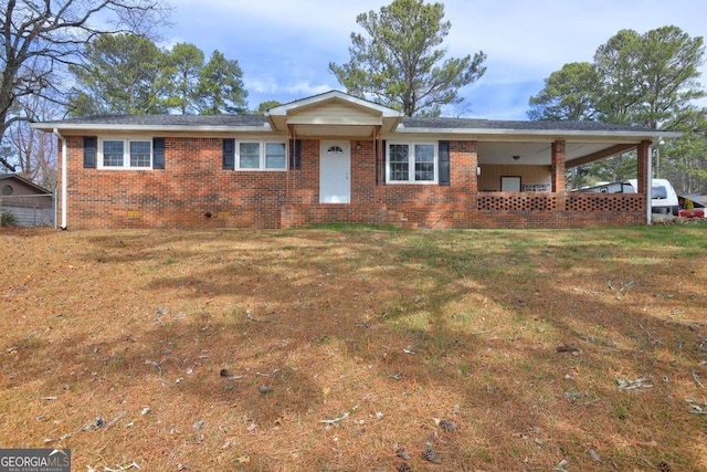 ranch-style home featuring a front lawn and brick siding