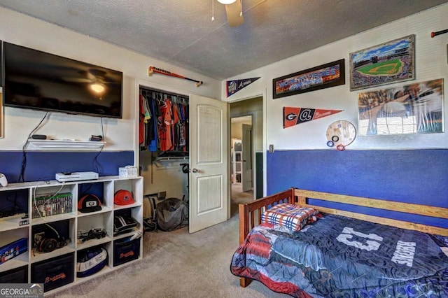 bedroom featuring carpet floors, a closet, and a textured ceiling