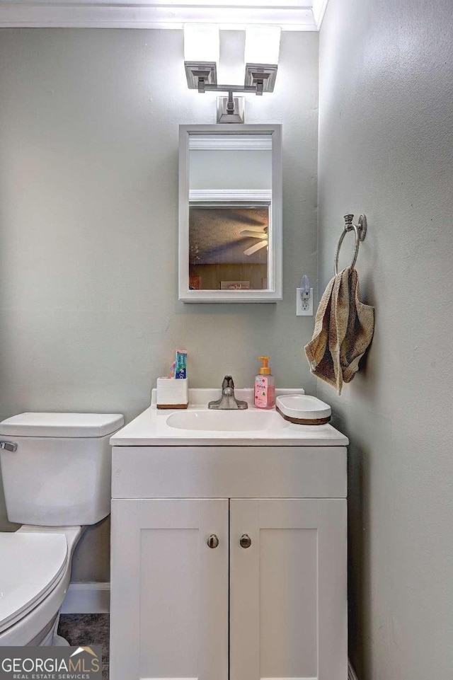 half bathroom featuring toilet and vanity