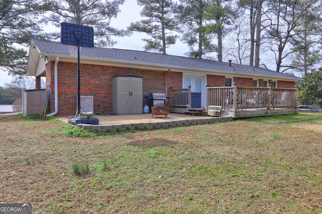 back of house with a patio area, brick siding, a yard, and a deck