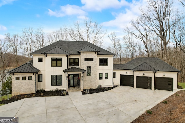 modern inspired farmhouse featuring driveway, metal roof, roof with shingles, an attached garage, and a standing seam roof