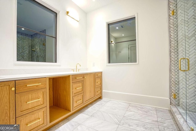 bathroom with marble finish floor, a shower stall, baseboards, and vanity