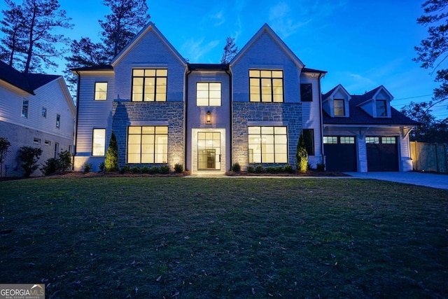 view of front of house featuring a garage, driveway, and a front yard