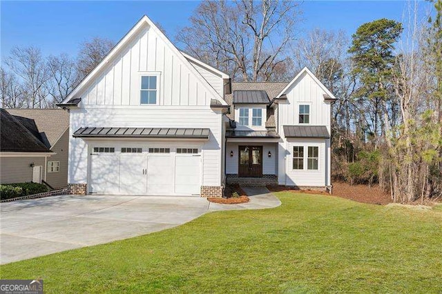 modern inspired farmhouse featuring board and batten siding, a front yard, a standing seam roof, and driveway