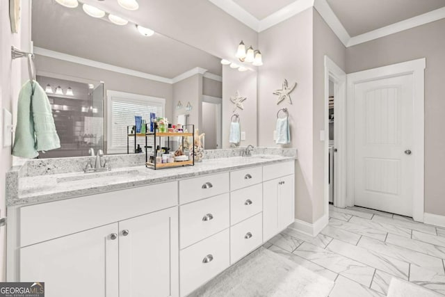 bathroom with marble finish floor, double vanity, ornamental molding, a sink, and baseboards