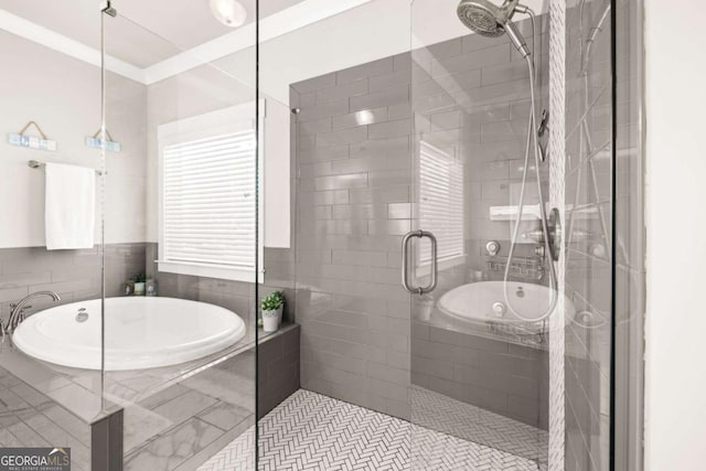 full bath with a garden tub, ornamental molding, and a tile shower