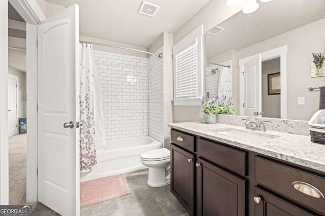 bathroom featuring toilet, shower / tub combo, vanity, and visible vents