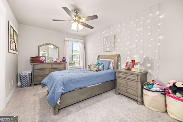 bedroom with baseboards, ceiling fan, and light colored carpet