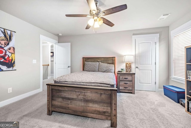 bedroom featuring baseboards, ceiling fan, visible vents, and light colored carpet