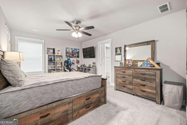 bedroom featuring ceiling fan, visible vents, and light colored carpet