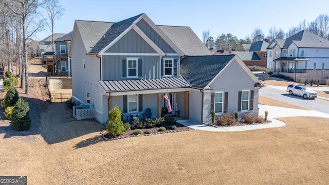 view of front facade with a porch, board and batten siding, a standing seam roof, metal roof, and a residential view