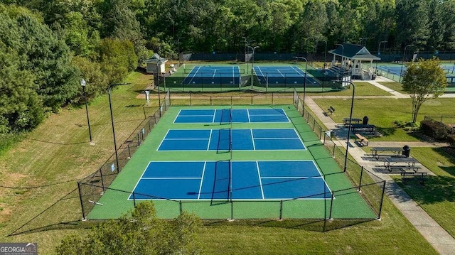 view of sport court featuring a yard, fence, and a gazebo