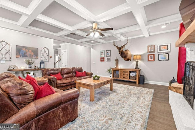 living room with a fireplace, baseboards, dark wood finished floors, and beamed ceiling