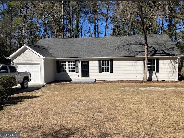 ranch-style house featuring a garage, roof with shingles, and a front yard