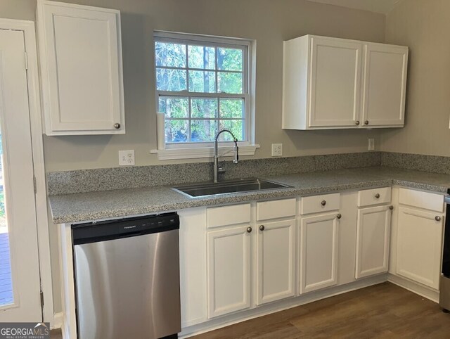 kitchen with white cabinets, dishwasher, and a sink