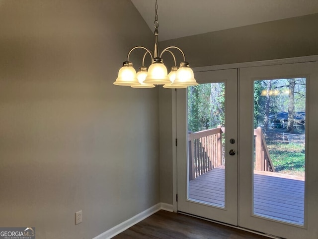 doorway to outside with baseboards, lofted ceiling, dark wood-style flooring, french doors, and a notable chandelier