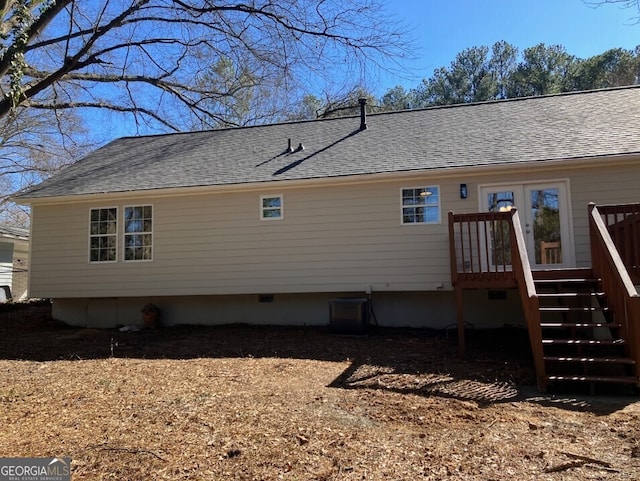 view of property exterior featuring a shingled roof, crawl space, stairway, and central AC unit