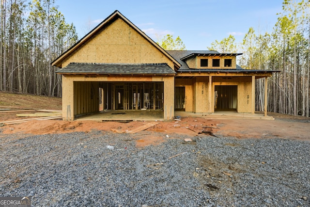 property under construction with a garage and a shingled roof