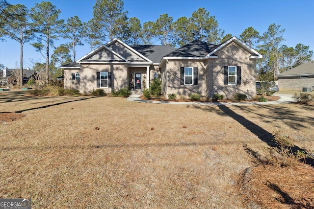 view of front of home featuring a front lawn and brick siding