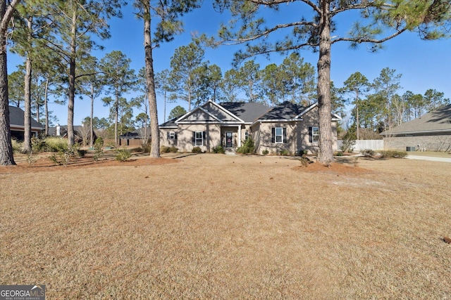 view of front of home with a front yard and fence