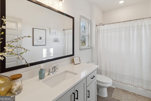 bathroom with recessed lighting, vanity, and toilet