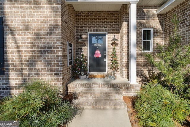 doorway to property with brick siding