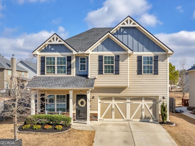 craftsman inspired home featuring concrete driveway, board and batten siding, an attached garage, and roof with shingles