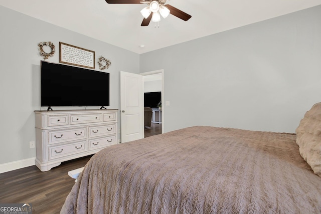 bedroom with dark wood-style floors, ceiling fan, and baseboards